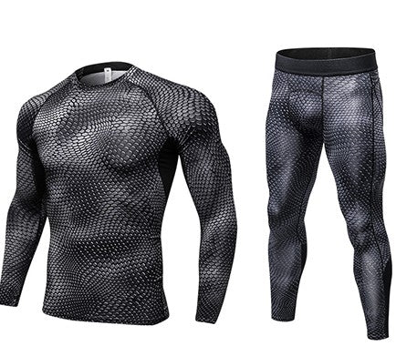 The Compression Cool Dry Sports Tights is a matching set of athletic wear, including a long-sleeve fitted shirt and leggings with a black and gray snakeskin pattern, made from quick-dry fabric for optimal comfort and performance. Displayed on white.
